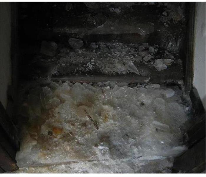 ice heaped on a stairwell leading to a cellar