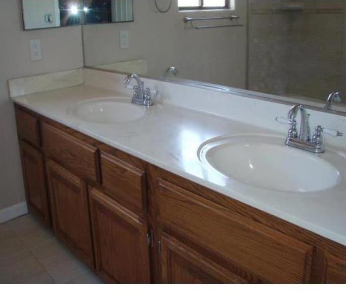 Clean bathroom with white sinks 