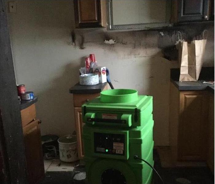 removed appliances from a burned kitchen with a green air scrubber working