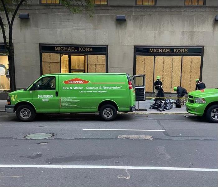 SERVPRO vehicles in front of boarded up store