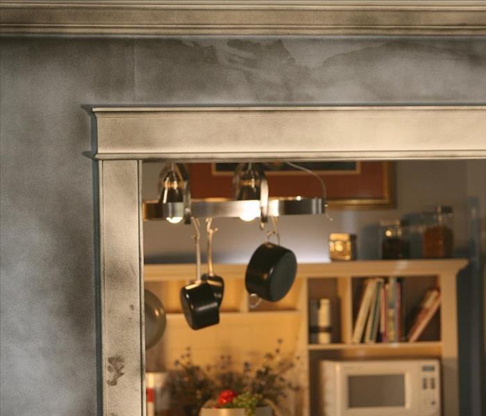 Fire damage to a home has left soot all over the walls and cabinetry.